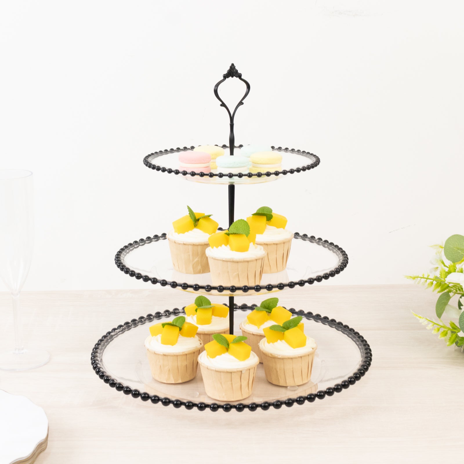 14" clear 3-tier dessert display stand with black beaded rim, featuring cupcakes.