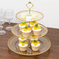 Clear gold glittered 3-tier dessert display stand with cupcakes and macarons.