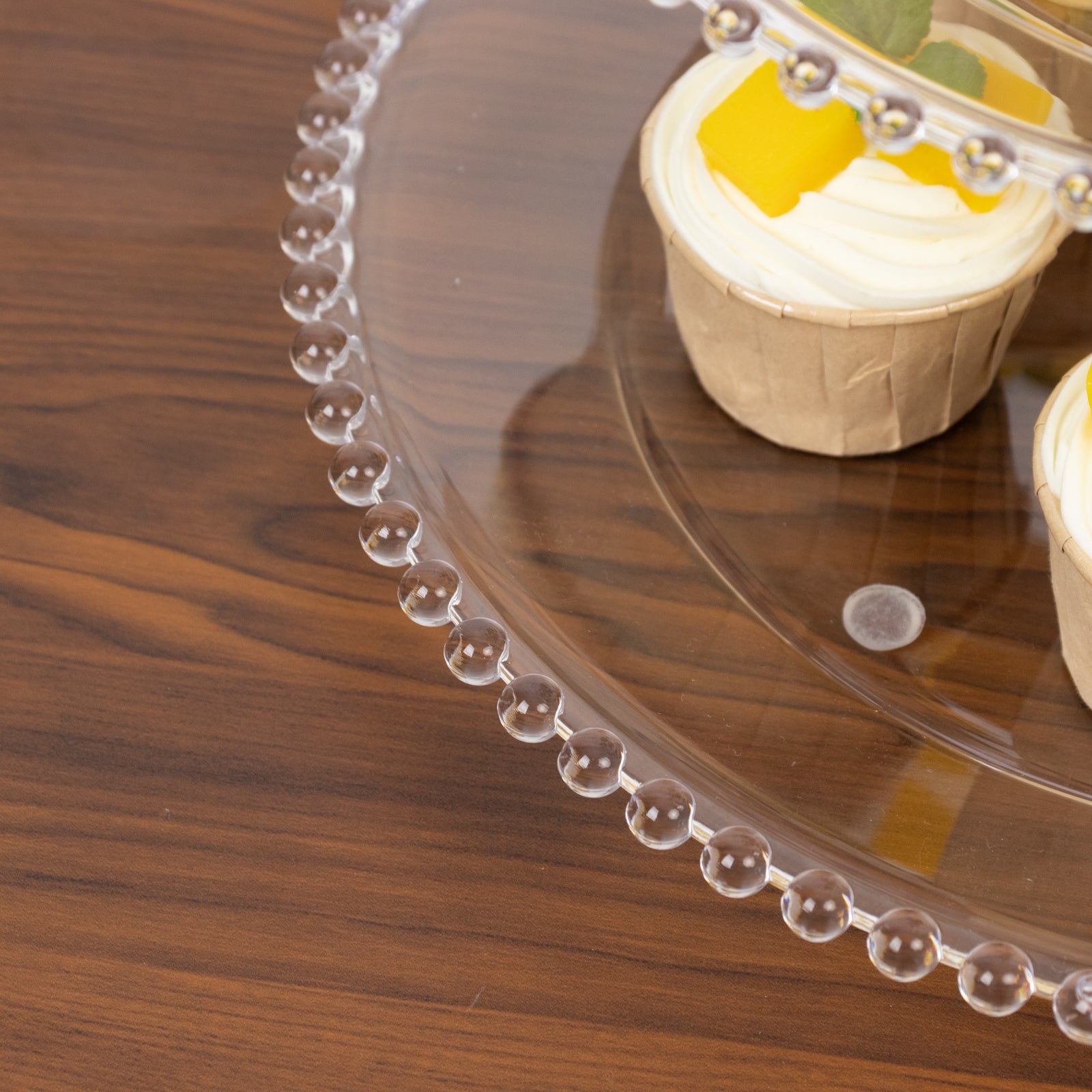 Clear 3-tier dessert display stand with beaded rim for cupcakes.
