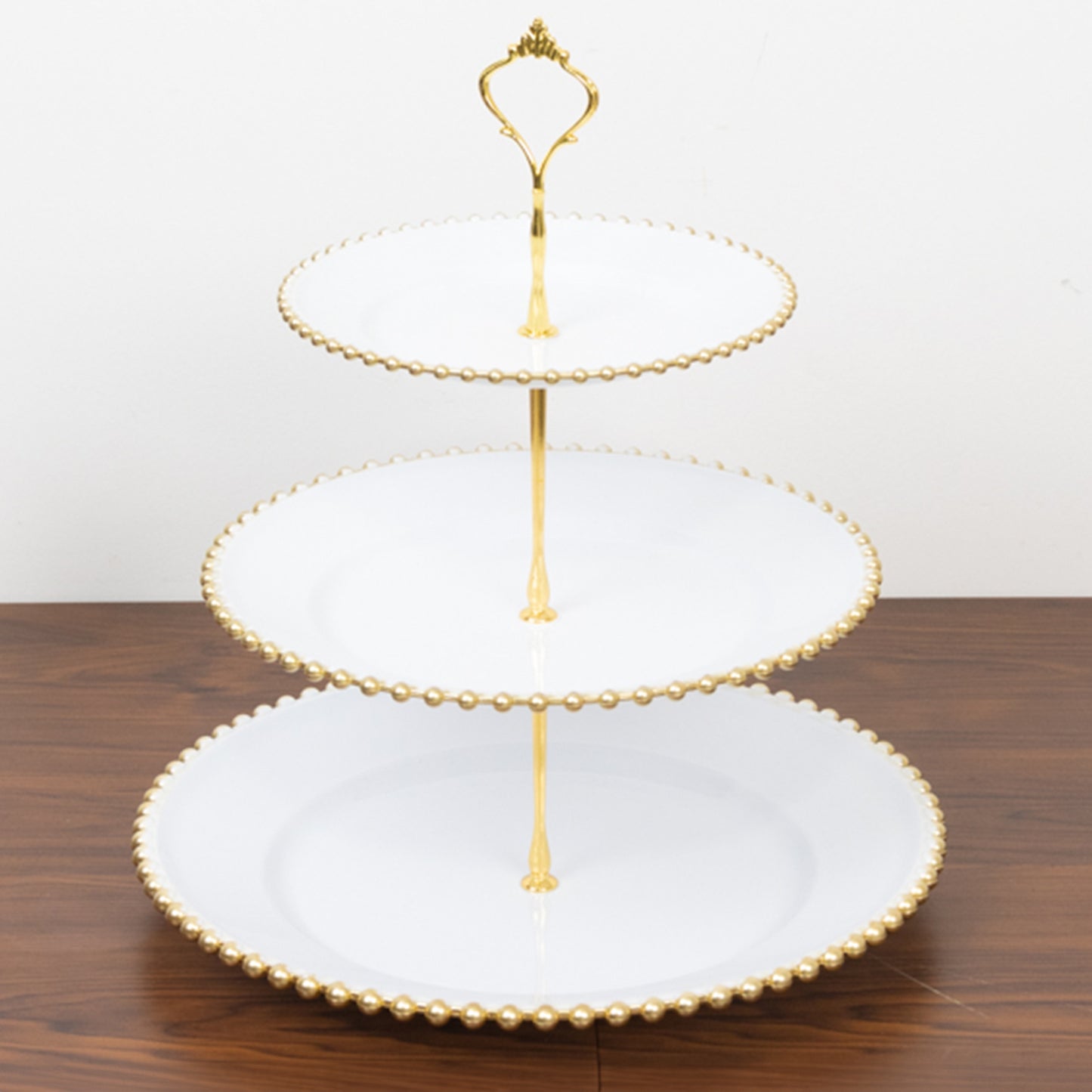 White 3-tier dessert display stand with gold beaded rim and top handle.