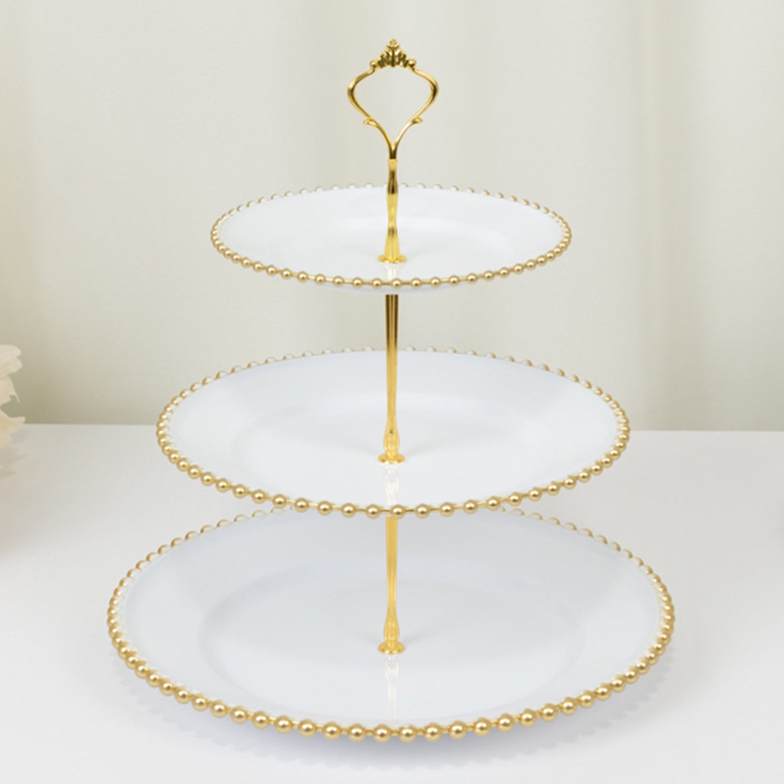 14" white 3-tier dessert display stand with gold beaded rim and top handle.
