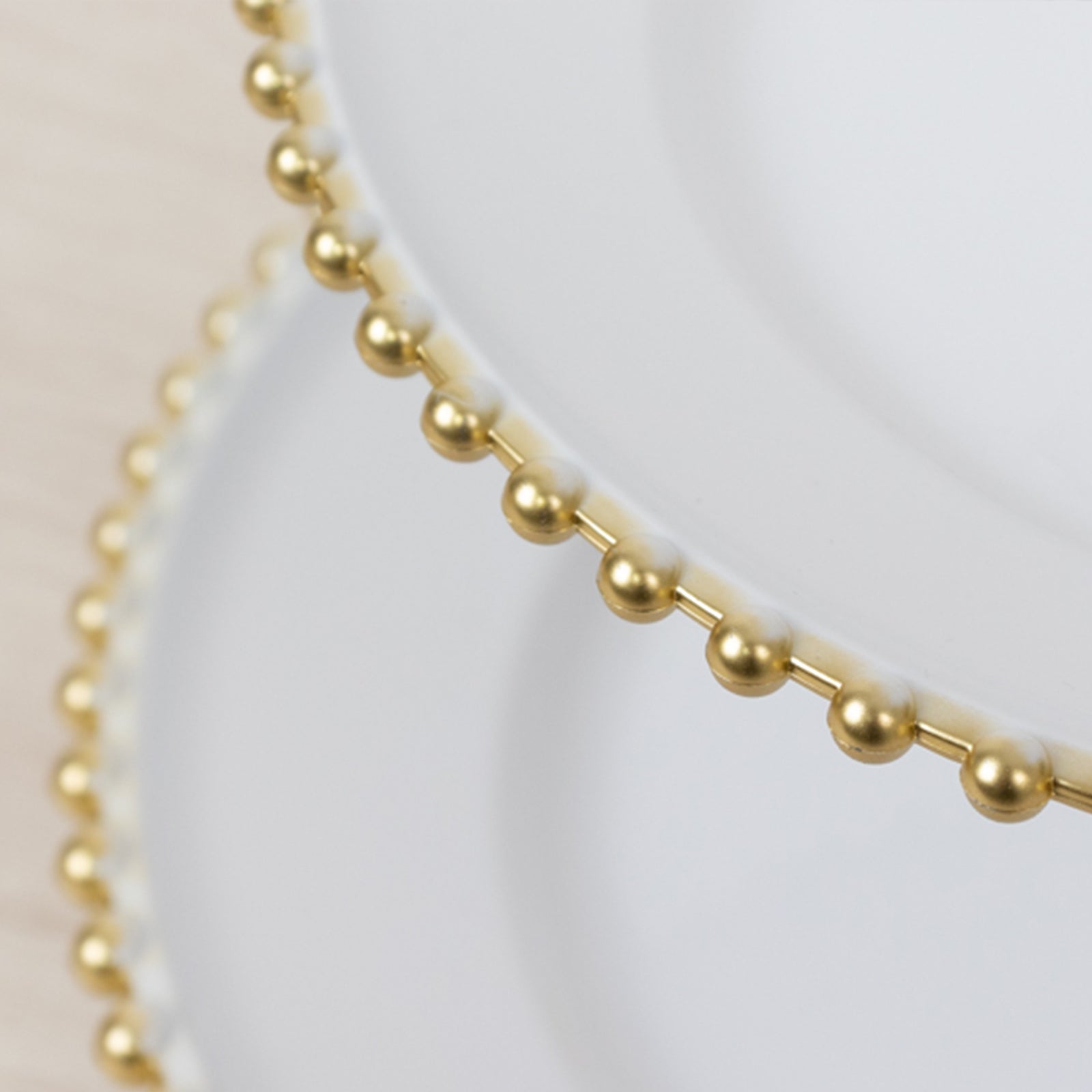 White 3-tier dessert display stand with gold beaded rim.