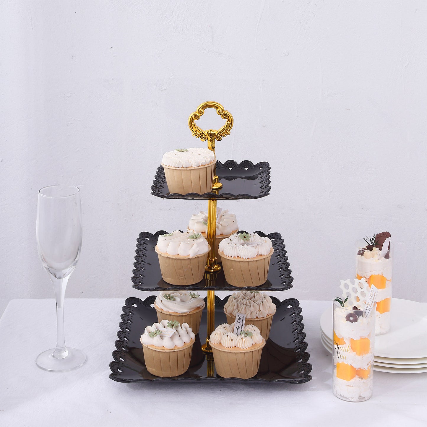 Black and gold 3-tier cupcake stand with heart wavy edges, perfect for desserts.