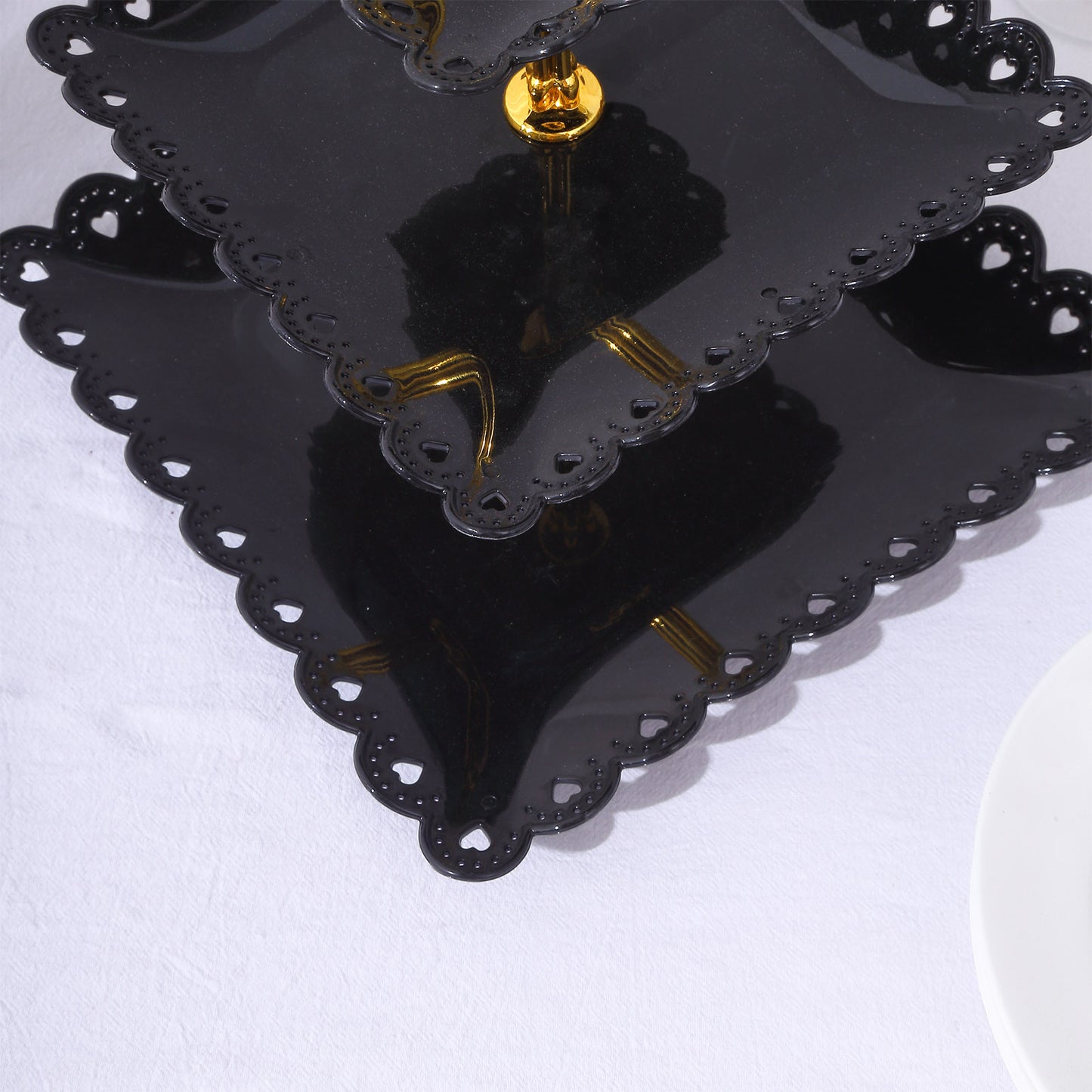 Black gold 3-tier cupcake stand with wavy edges and top handle.