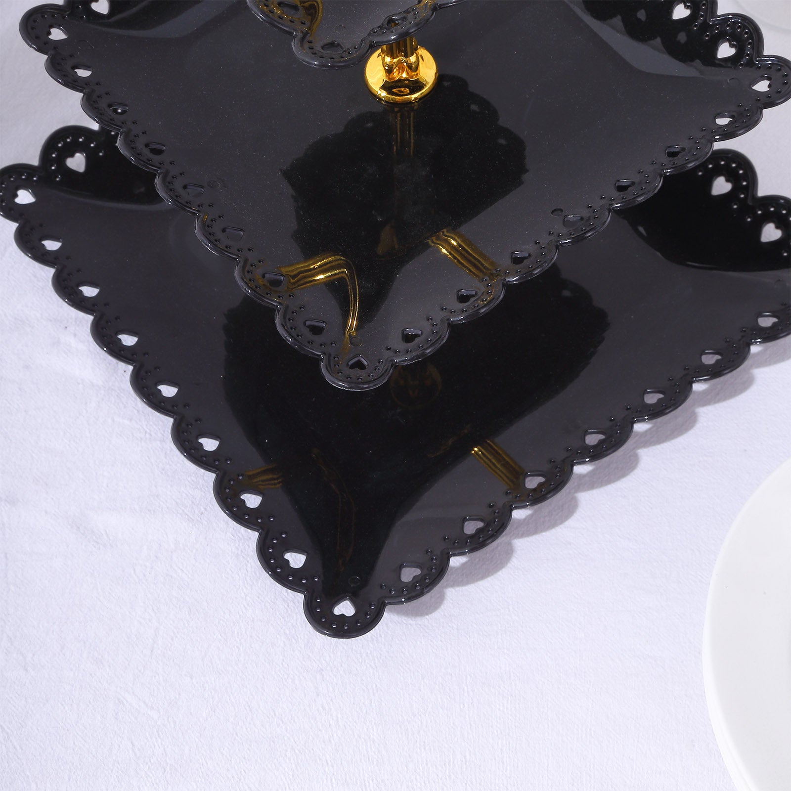 Black gold 3-tier cupcake stand with wavy edges and top handle.