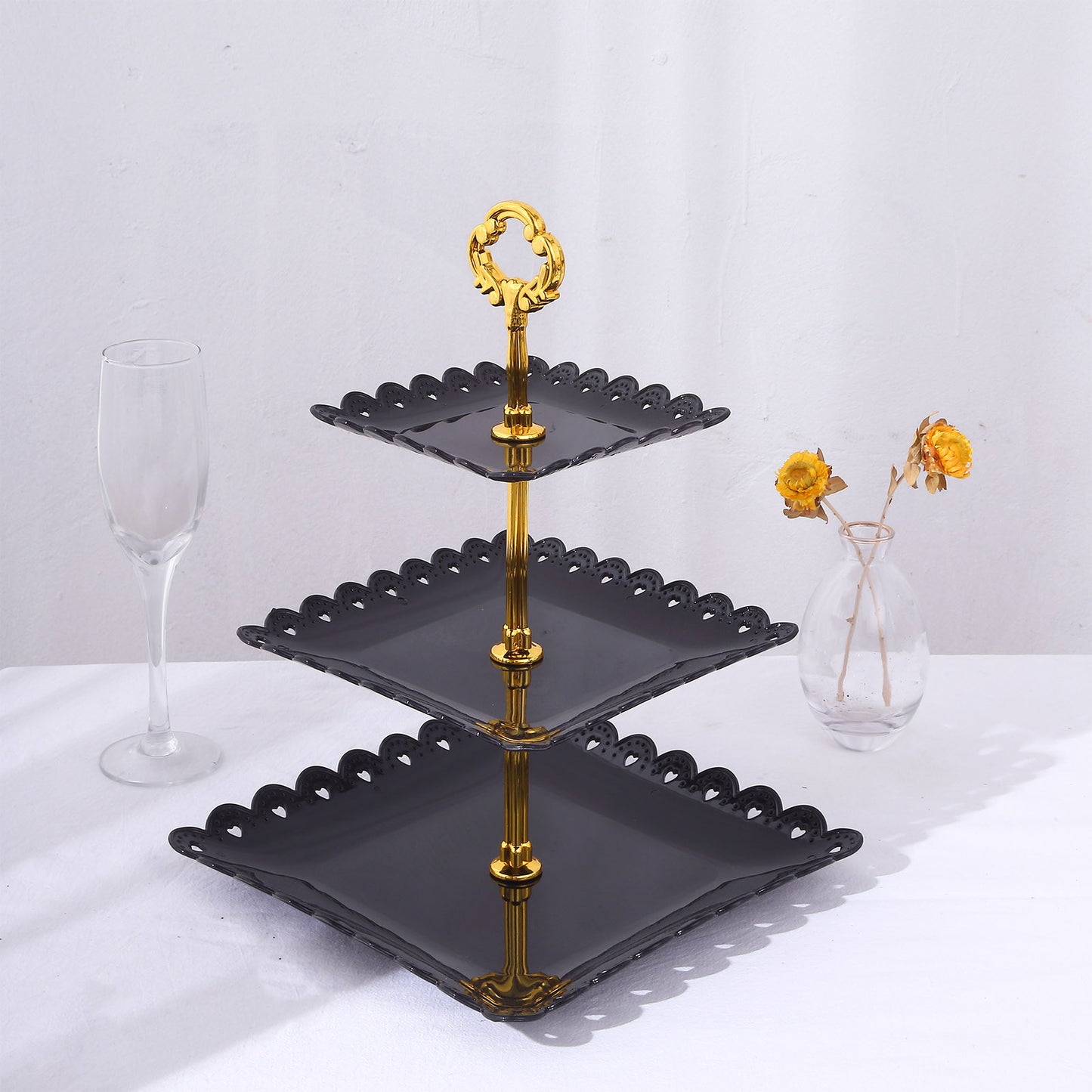 Black and gold 3-tier cupcake stand with heart wavy edges and top handle.