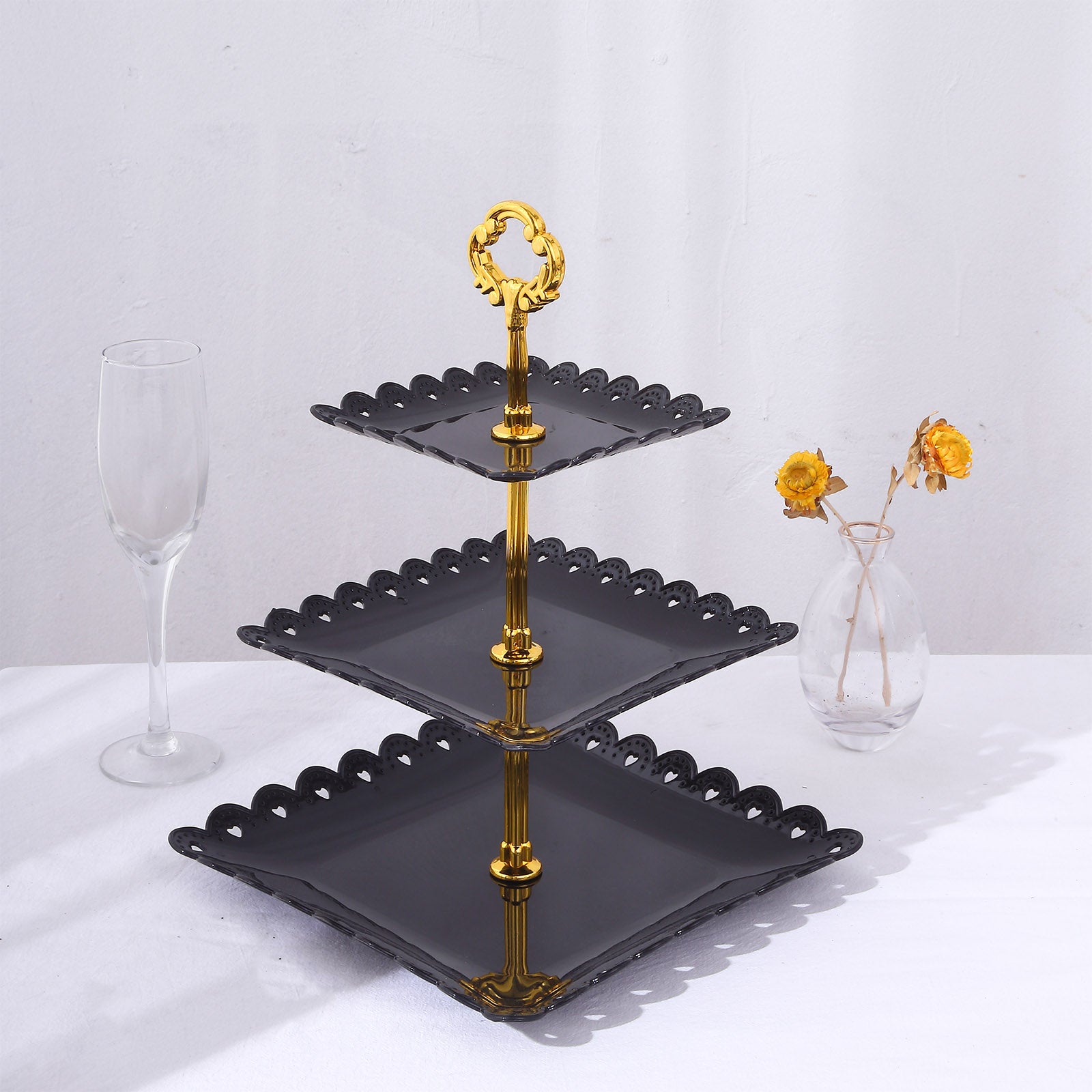 Black and gold 3-tier cupcake stand with heart wavy edges and top handle.