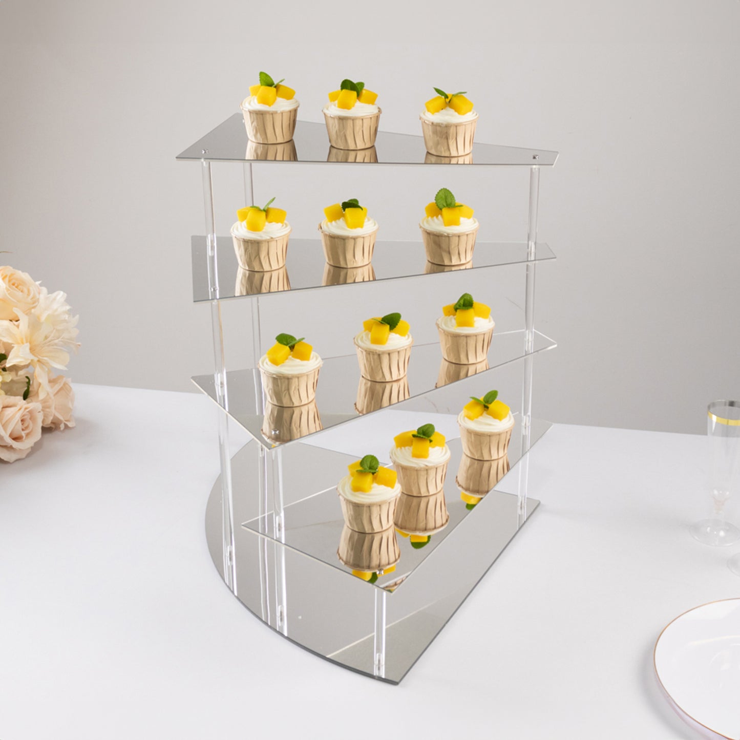 Silver acrylic cupcake stand with mirror finish displaying desserts.