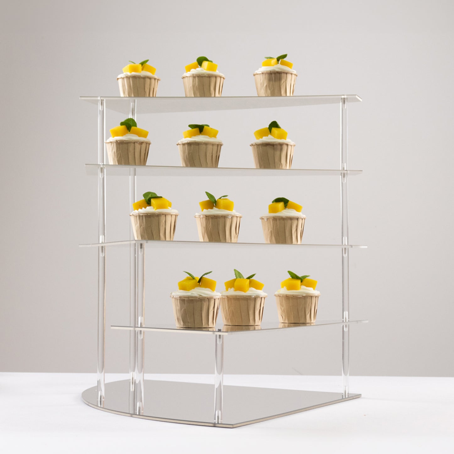 Silver acrylic cupcake stand displaying desserts.