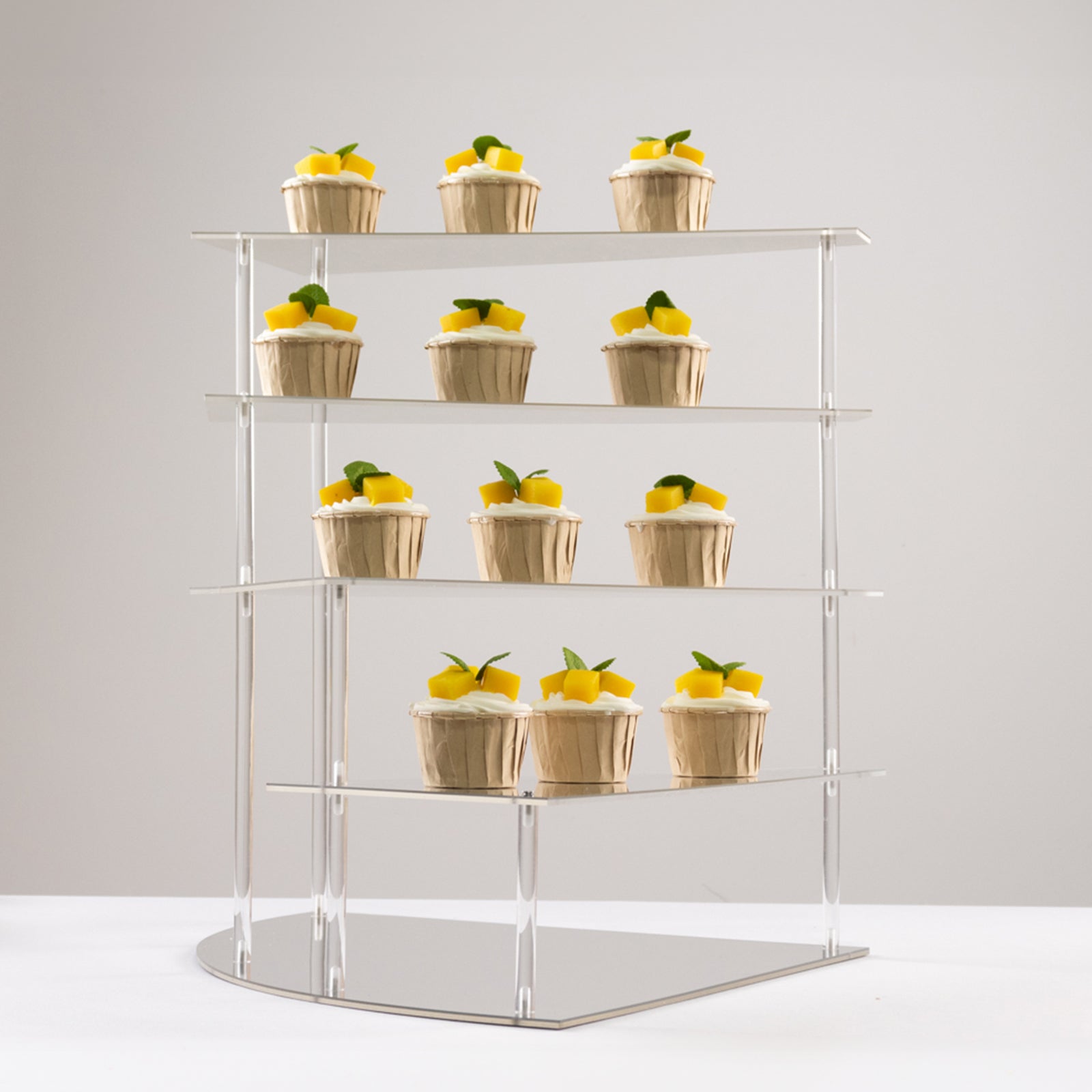Silver acrylic cupcake stand displaying desserts.