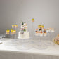 Clear acrylic 8-tier cake stand set with cupcakes and desserts.