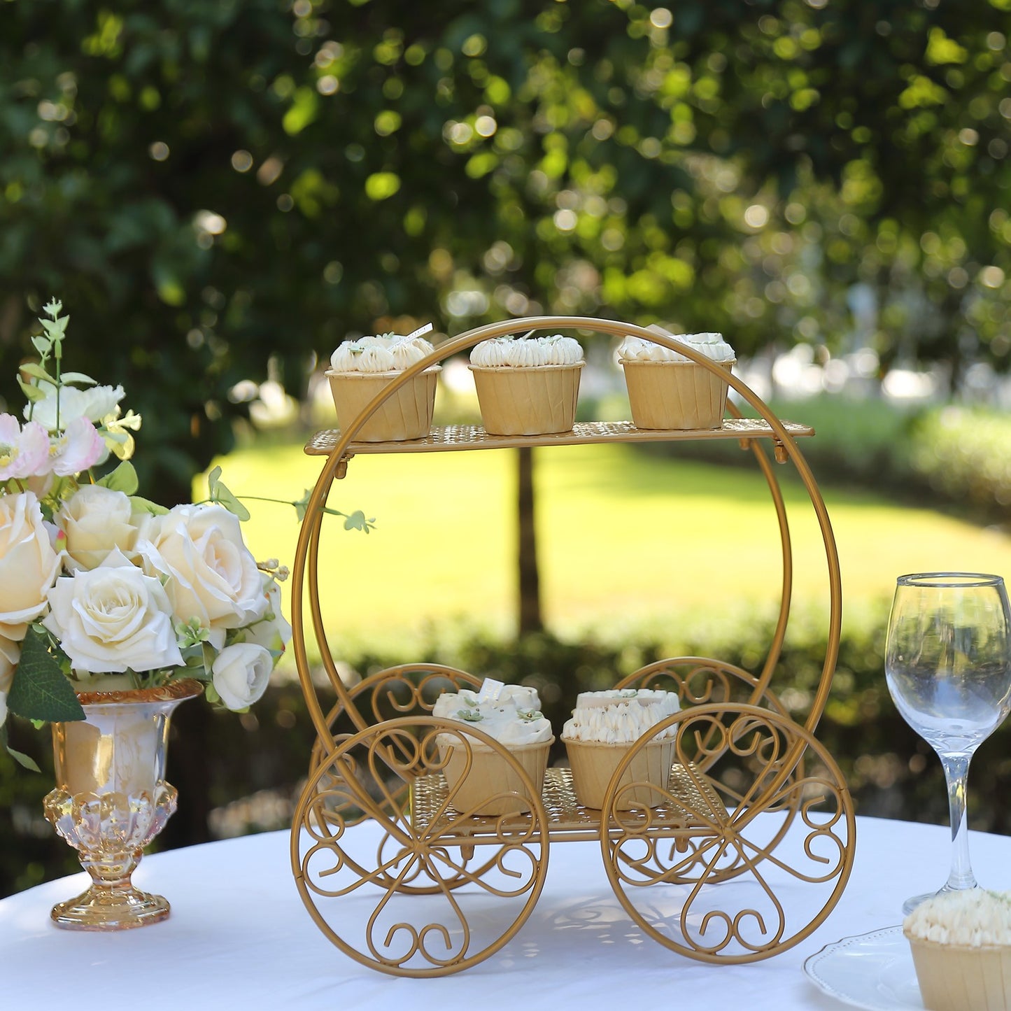 14" tall gold Cinderella carriage cupcake stand with desserts.