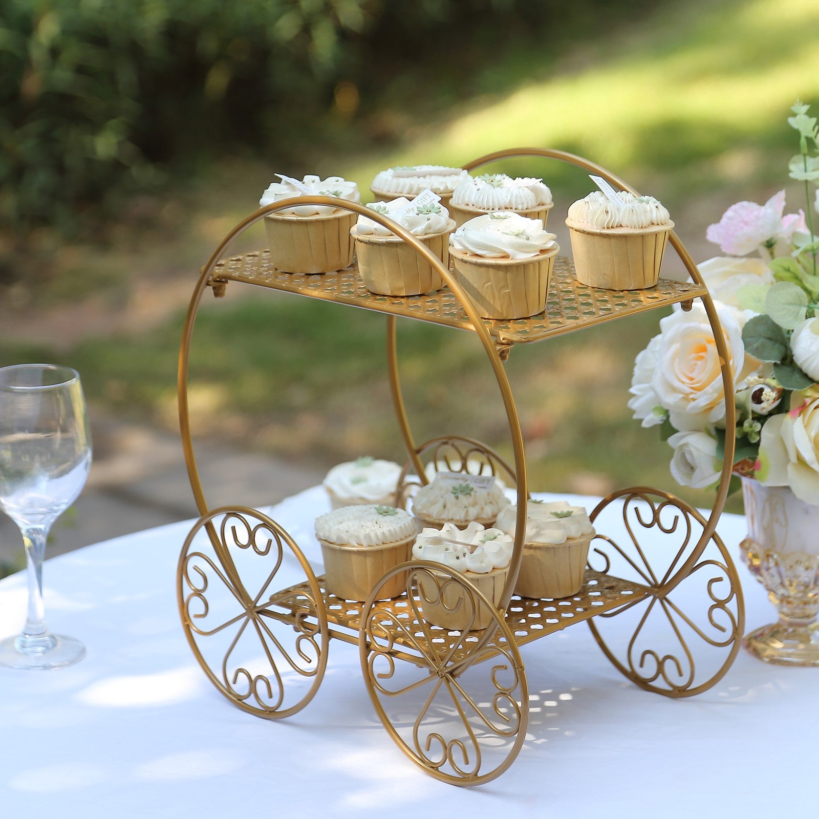 Gold 2-tier Cinderella carriage cupcake stand with decorative desserts.