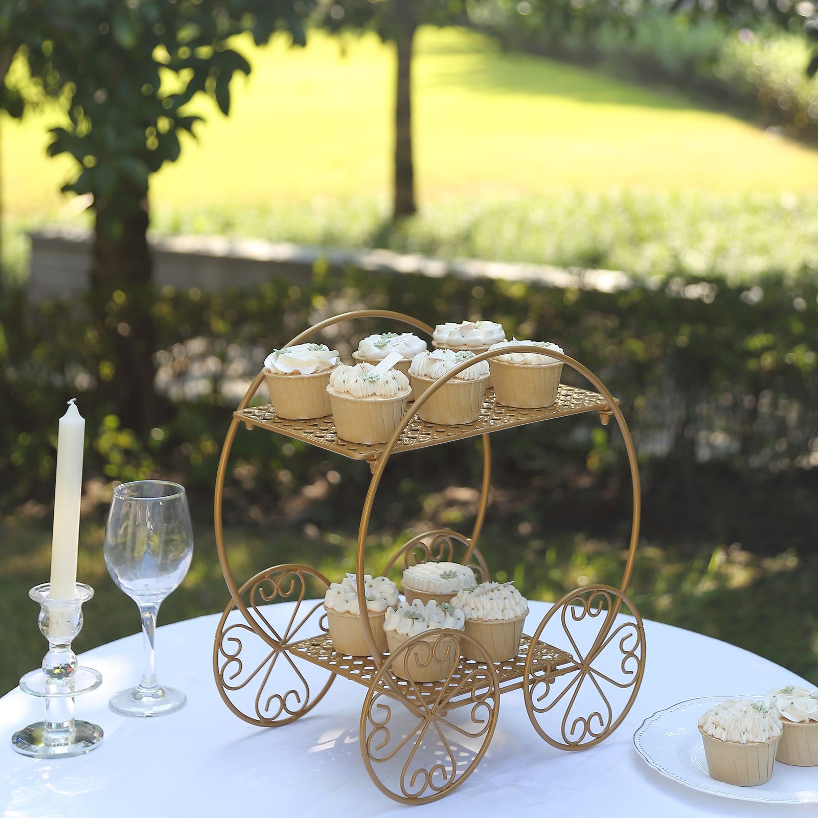 14" tall gold metal Cinderella carriage cupcake stand with desserts.