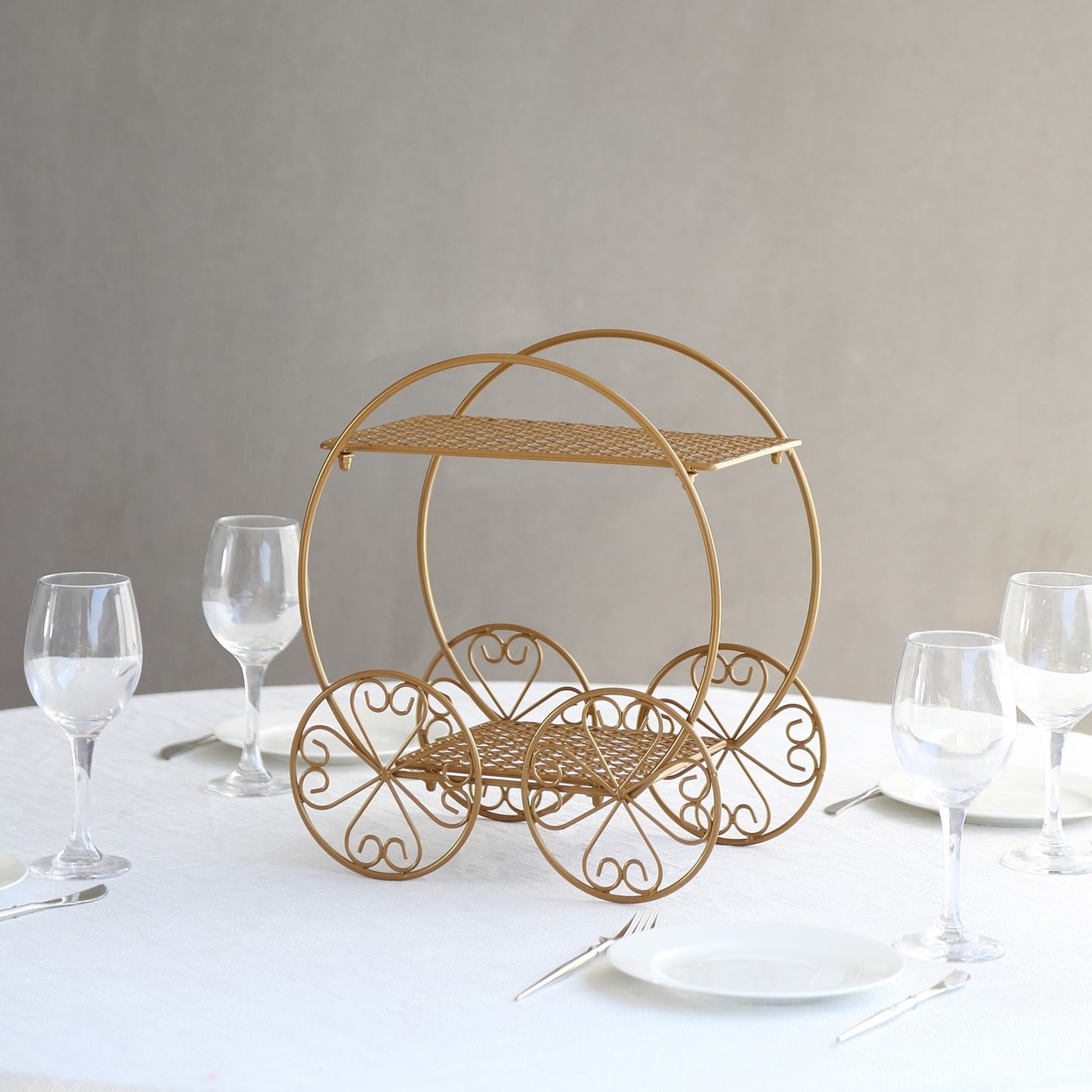 14" tall gold metal Cinderella carriage cake stand for weddings and parties.