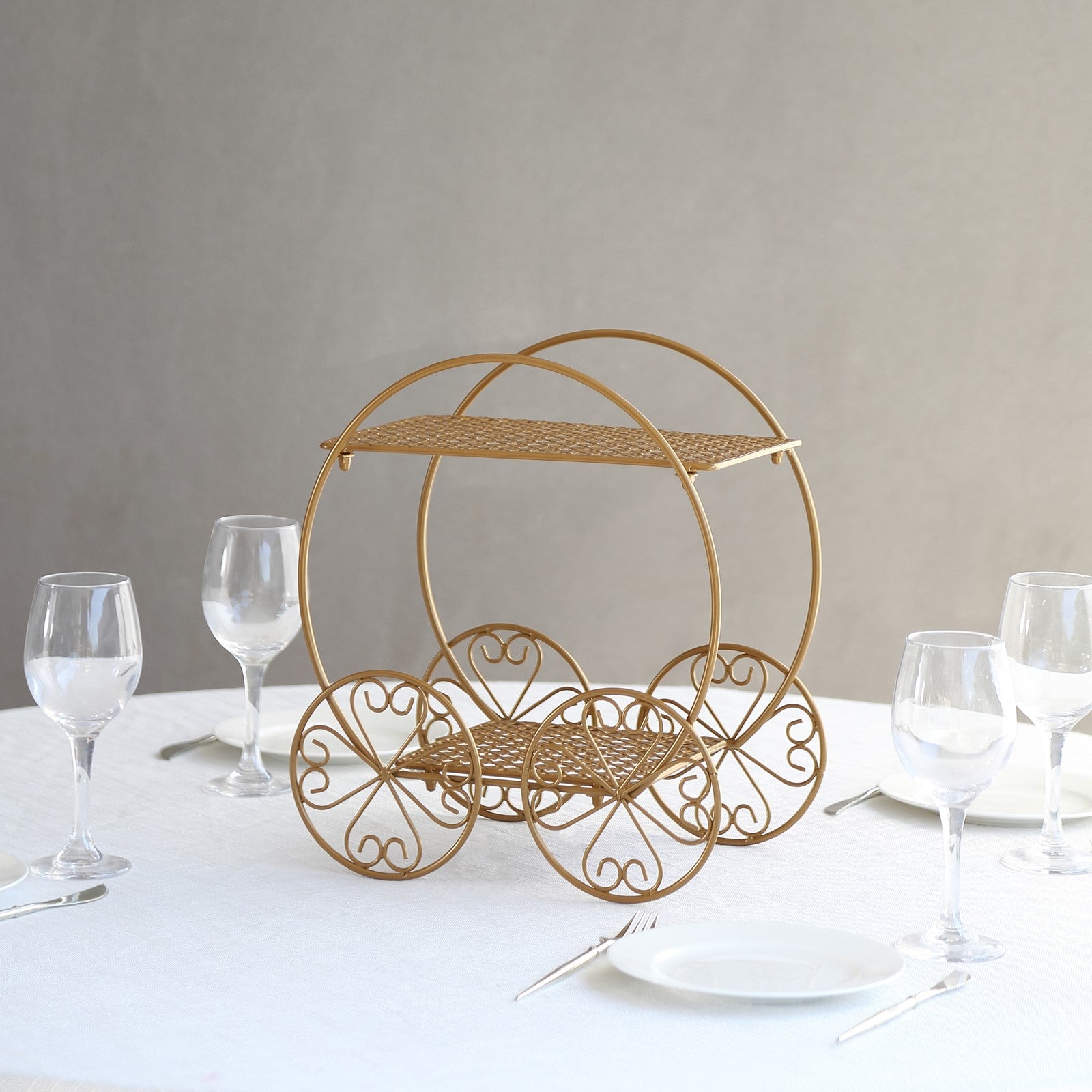 14" tall gold metal Cinderella carriage cake stand for weddings and parties.
