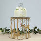 Gold carousel cake stand with hanging acrylic beads and decorative horses.