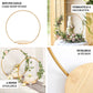 Gold round metal floral hoop cake stand with wooden base for dessert display.