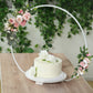 Whitewash floral hoop cake stand with roses, perfect for dessert display.