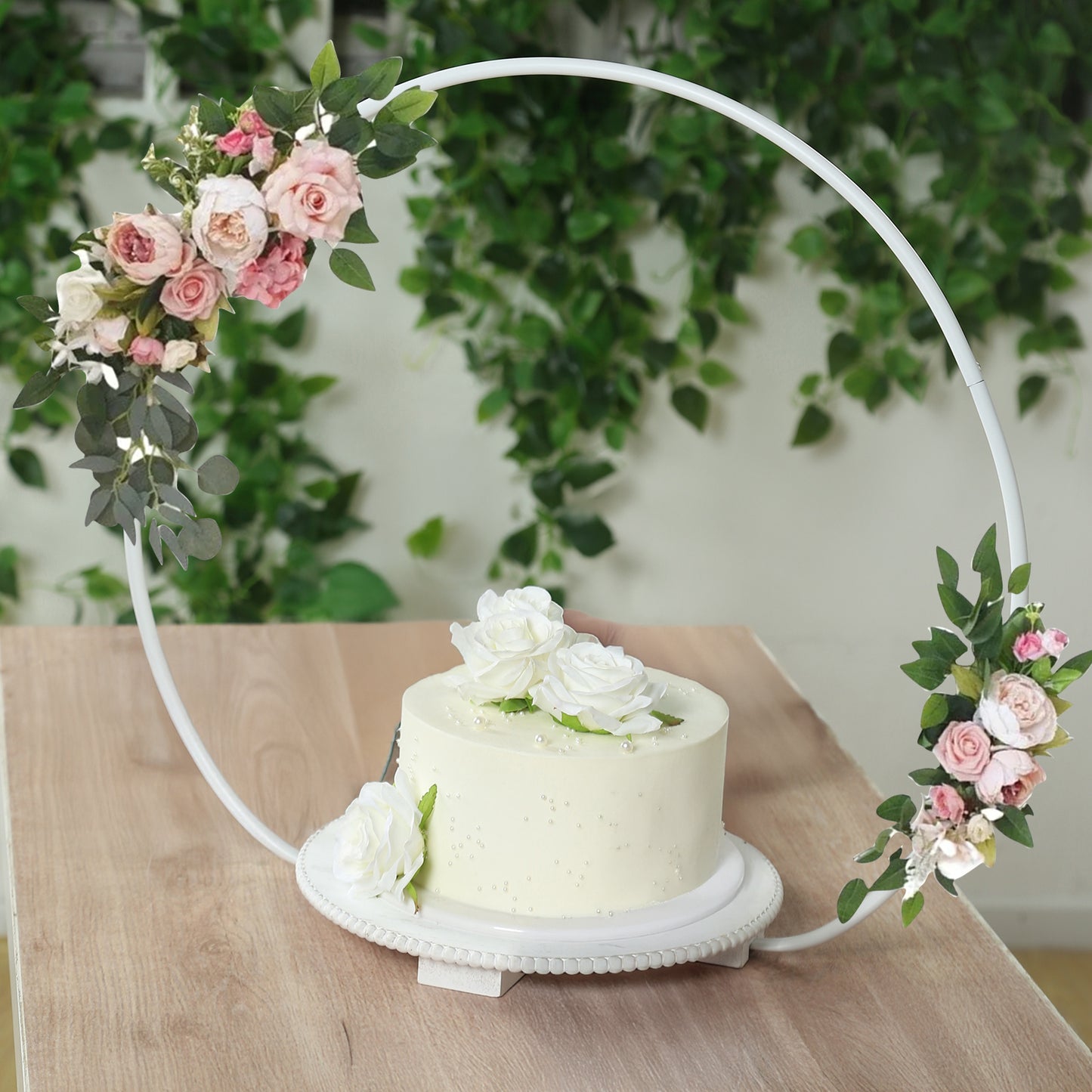 Whitewash floral hoop cake stand with roses, perfect for dessert display.