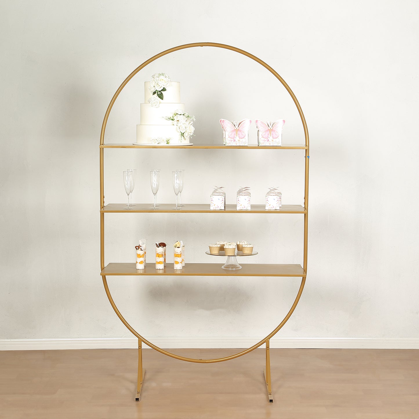 6.5ft gold metal arch cake display stand with shelves for desserts and cupcakes.