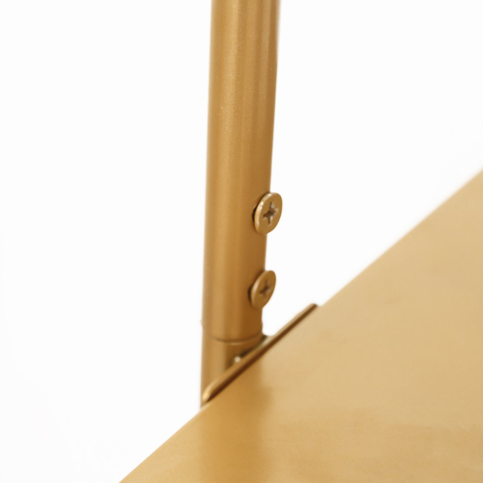 Gold metal arch cake display stand detail close-up.