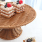 Natural rattan wicker pedestal cupcake stand with desserts.