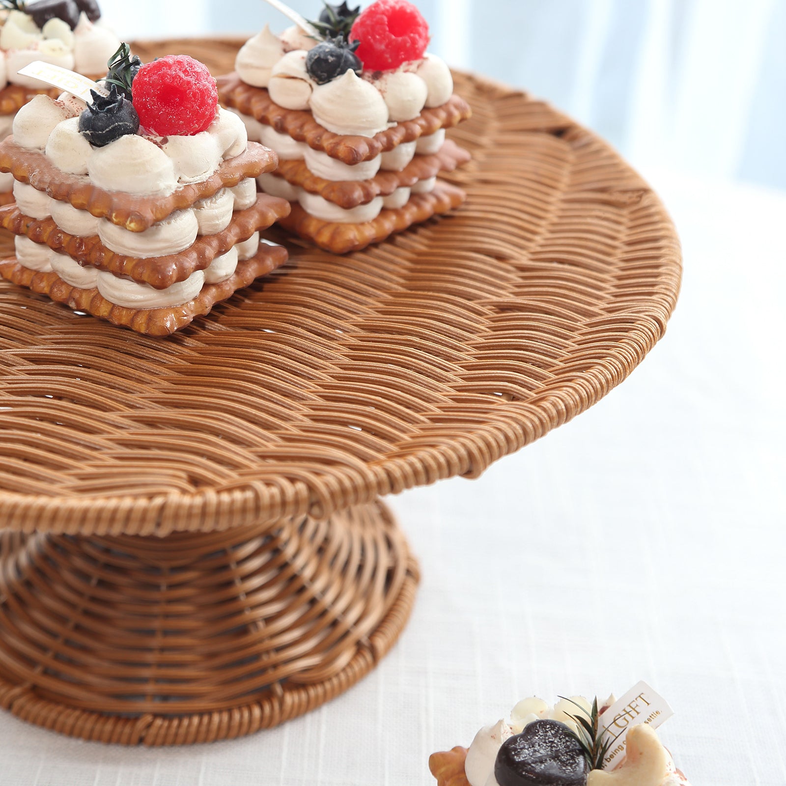 Natural rattan wicker pedestal cupcake stand with desserts.