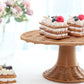 Natural rattan wicker pedestal cupcake stand with desserts on display.