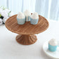 Natural brown wicker pedestal cupcake stand with cupcakes.