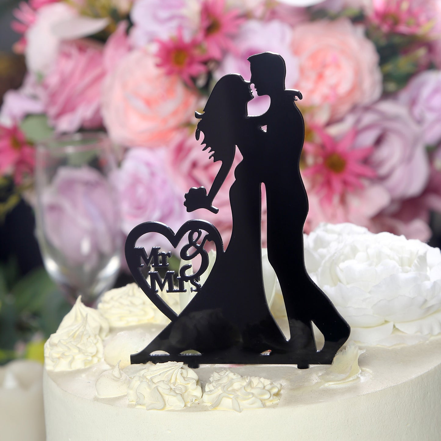 Black acrylic Mr and Mrs wedding cake topper with bride and groom silhouette.