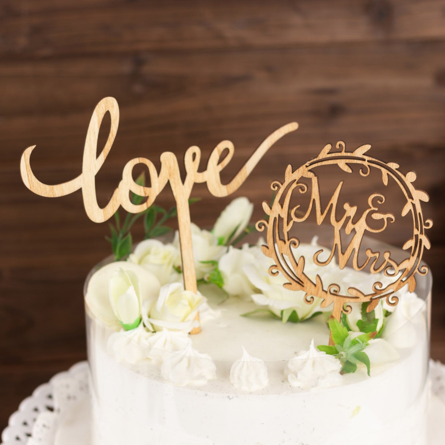 Natural wooden wedding cake topper set with "Mr & Mrs" and "Love" design.