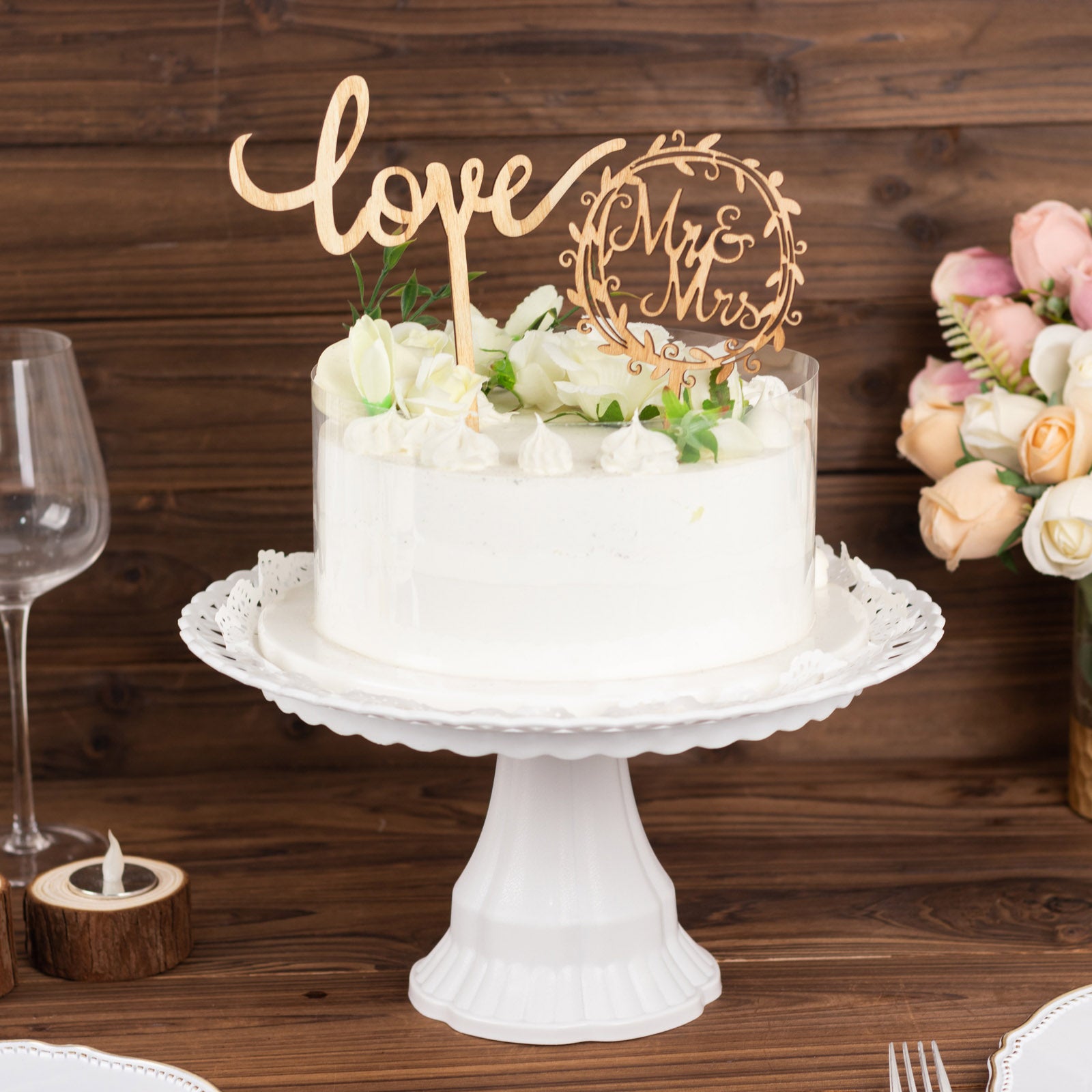 Rustic wooden Mr & Mrs and Love cake topper on a white cake.