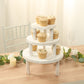 Whitewash wooden pedestal cupcake stands with cupcakes on a rustic table.