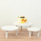 Set of 3 whitewash wooden pedestal cupcake stands with removable legs.