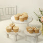 Whitewash wooden cupcake stands displaying dessert treats.
