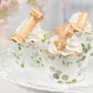 White green truffle cup dessert liners with eucalyptus leaves print on cupcakes.