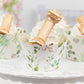 White dessert liners with eucalyptus leaves print for truffles or cupcakes.