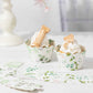White and green truffle cup dessert liners with eucalyptus leaves print.