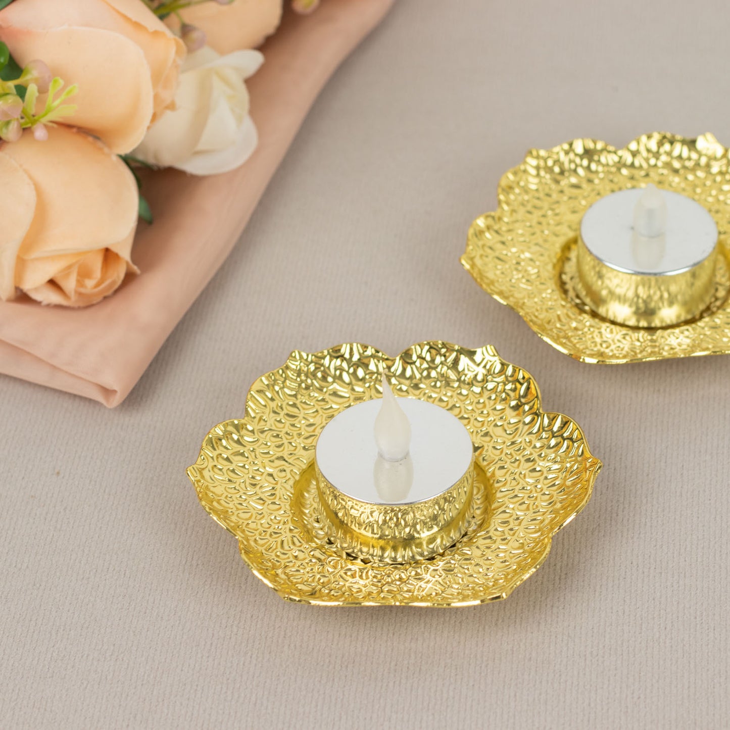 Shiny gold plum blossom tealight candle holders in a vintage style.