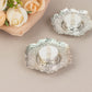 Shiny silver metal plum blossom tealight candle holders on a soft background.