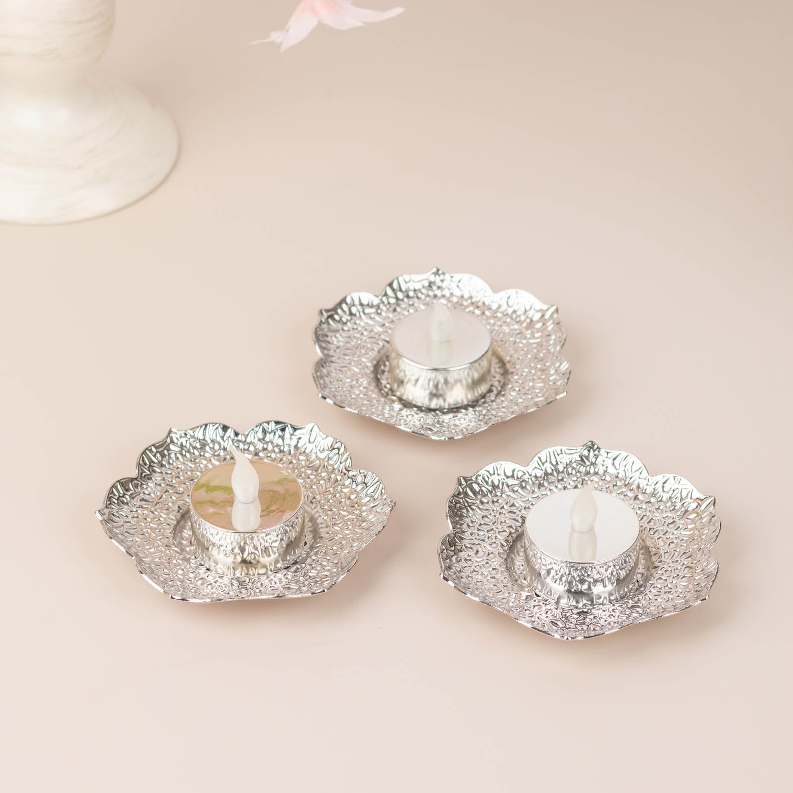Shiny silver plum blossom tealight candle holders, vintage mini tea cup saucers.
