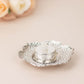 4" shiny silver metal plum blossom tealight candle holder on vintage saucer.