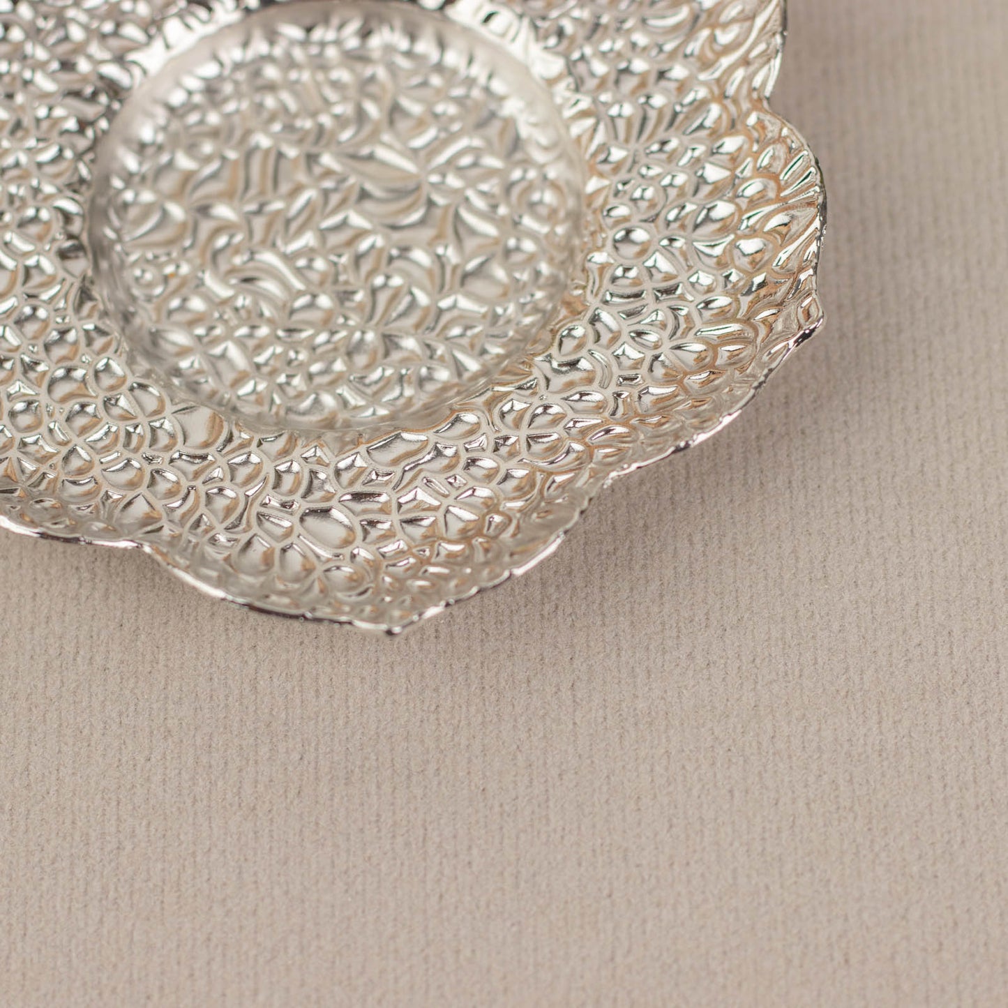 Shiny silver metal plum blossom tealight candle holder saucer.