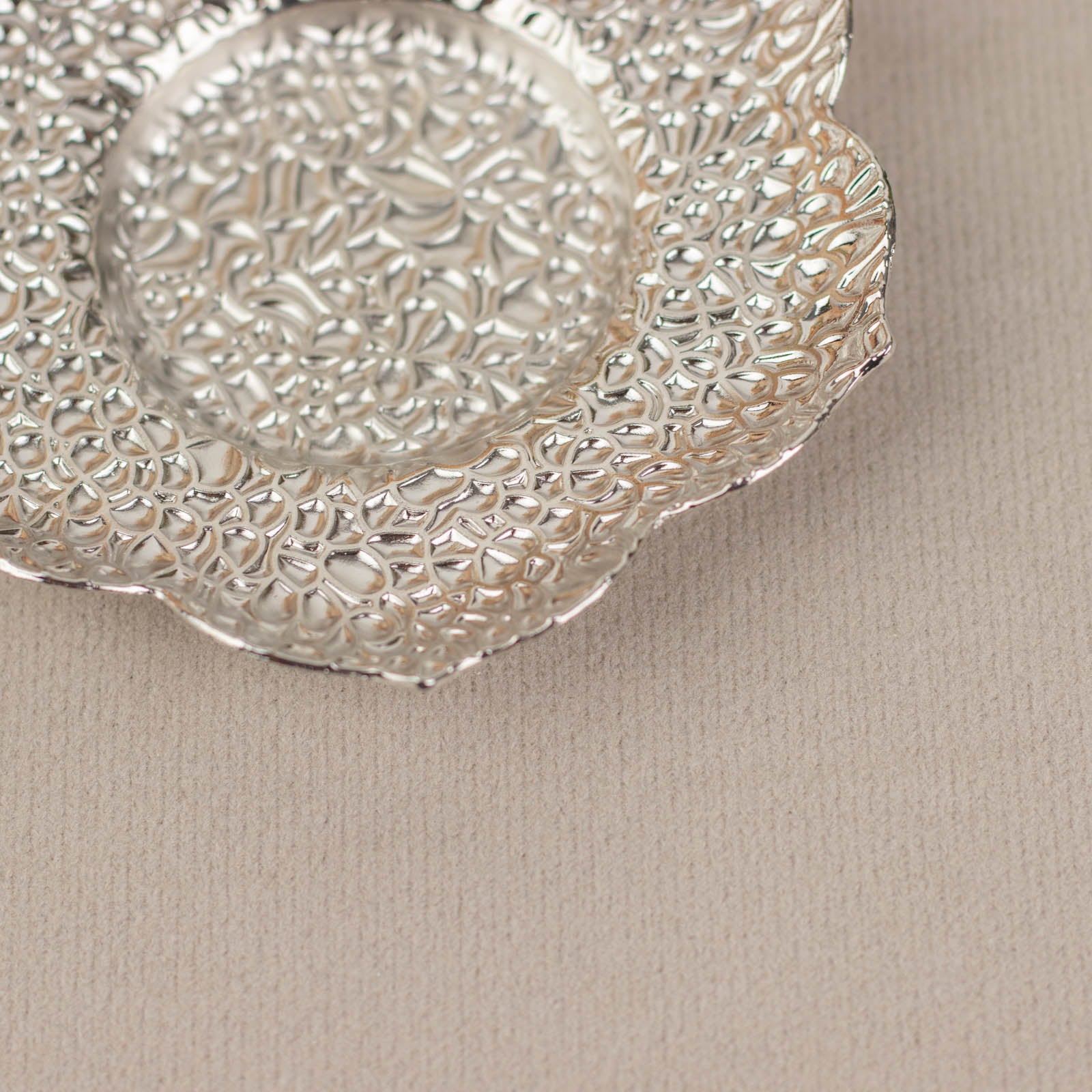 Shiny silver metal plum blossom tealight candle holder saucer.