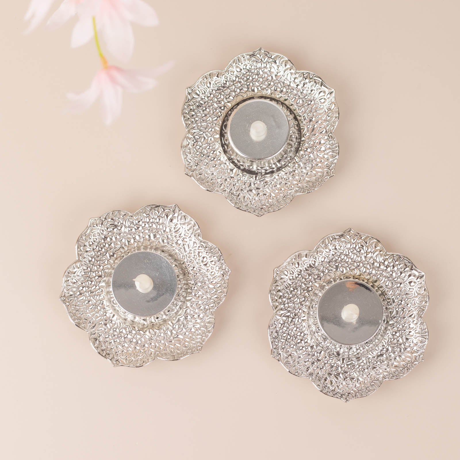 Shiny silver metal plum blossom tealight candle holders, vintage mini tea cup saucers.