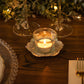 Shiny silver metal plum blossom tealight candle holder on a table setting.