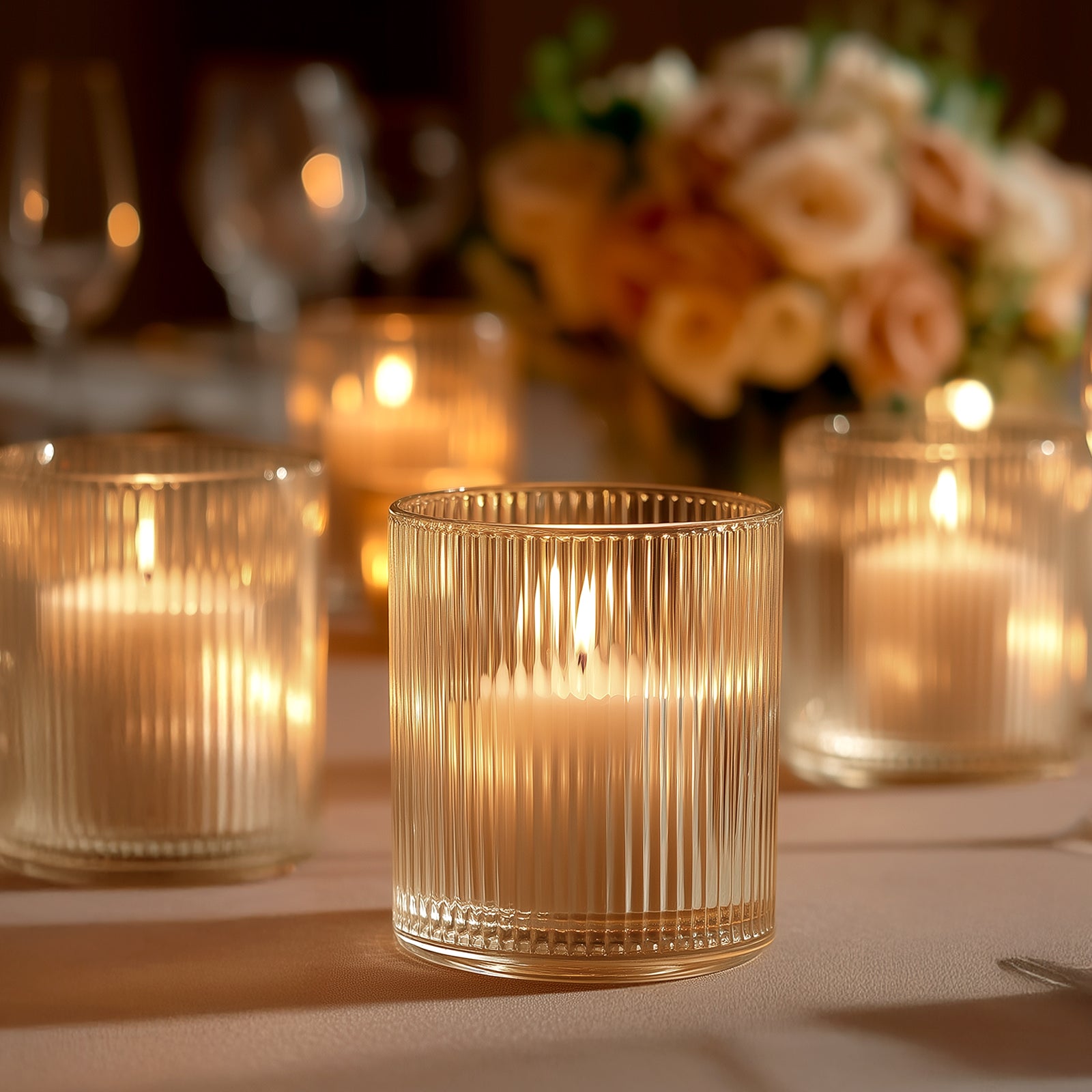 Amber gold ribbed glass votive candle holder with tealight candle.