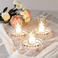 Clear glass candle holder trays with beaded rims and candles.