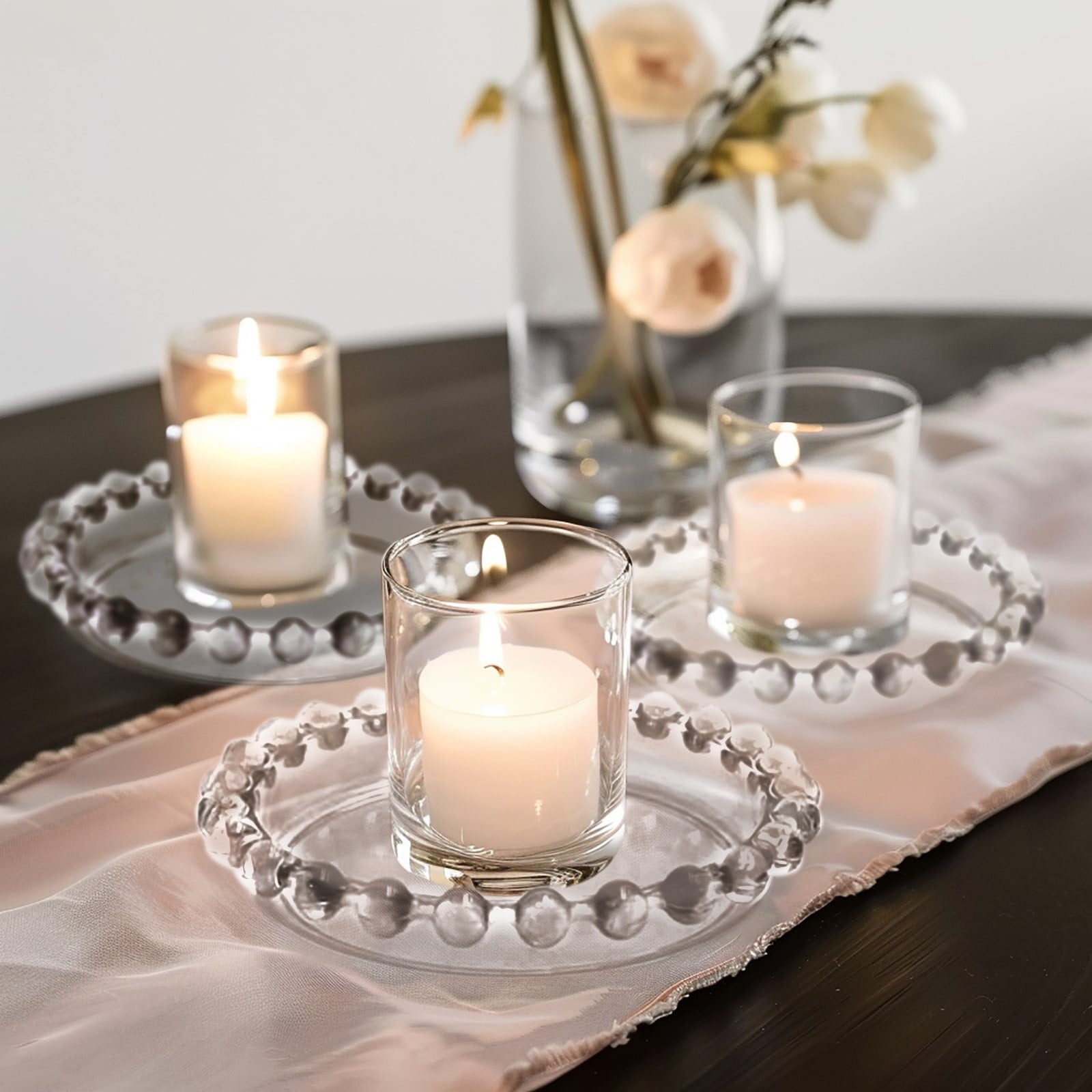 Clear glass candle holder trays with beaded rims, perfect for elegant decor.